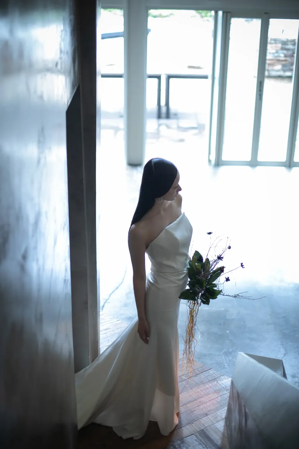 nae. ATELIERナエアトリエのシンプルで印象的なマーメイドラインのウェディングドレスを着てブーケを持った女性